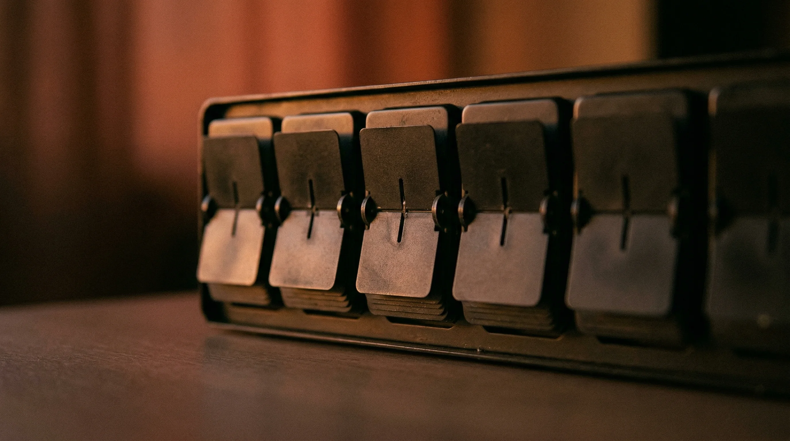 Digital illustration for article section "The Numbers Tell Stories" in "How ARC-AGI Became AI's Gold Standard for Intelligence Testing" - A minimalist, conceptual close-up of an elegant, vintage analog split-flap display resting on a smoo...